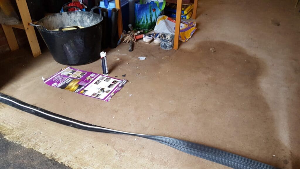Water coming into garage under door due to lack of weatherproof strip