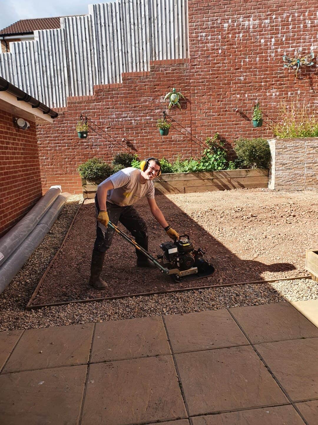 Me - Tristan - using a plate compactor - wacker plate - for artificial grass project