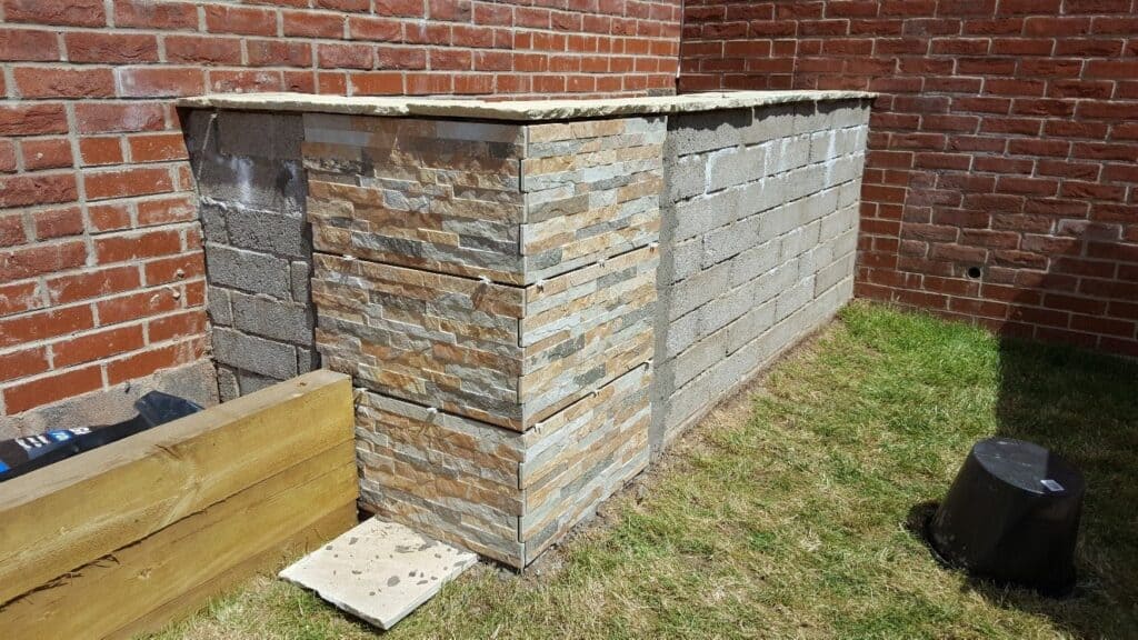 Tiling an external concrete block wall with porcelain tiles
