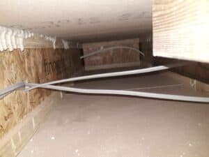 Various electrical cables underneath floorboards