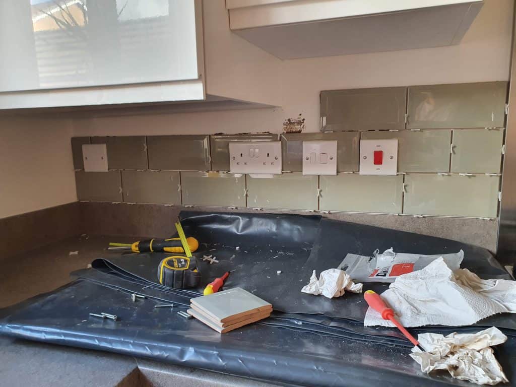 Ongoing work when tiling under kitchen cabinets