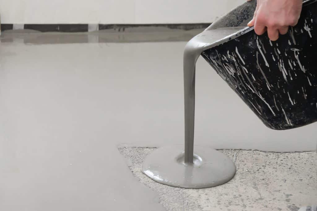 Self levelling epoxy being poured with some bubbles visible