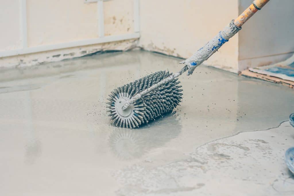 Using a metal needle roller for an epoxy floor