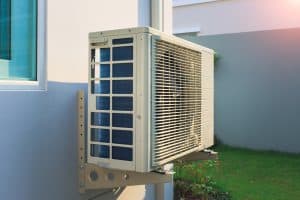 An outdoor wall mounted AC compressor air con unit