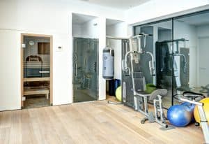 Various gym equipment on a room with an in built shower