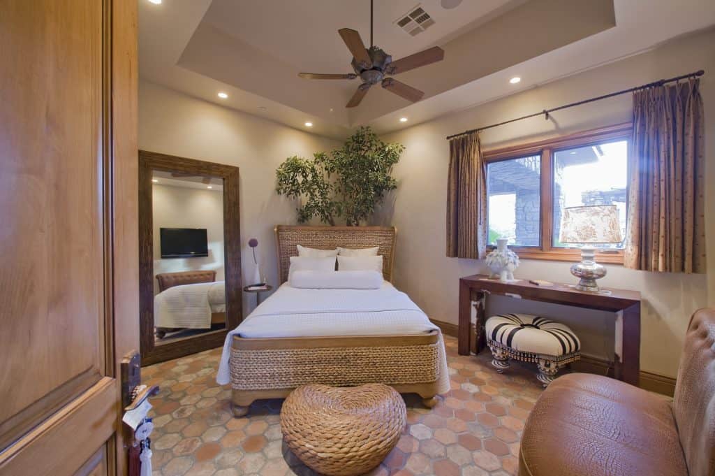 A bedroom with mosaic tiles on the floor