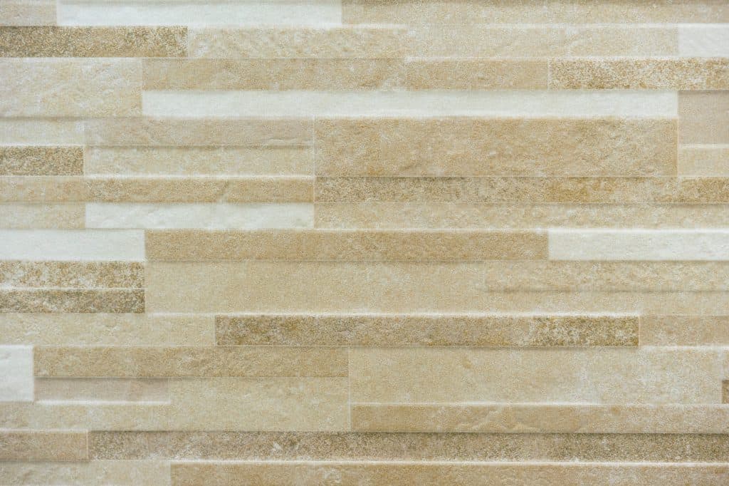 Beige porcelain tiles with a small stone texture pattern