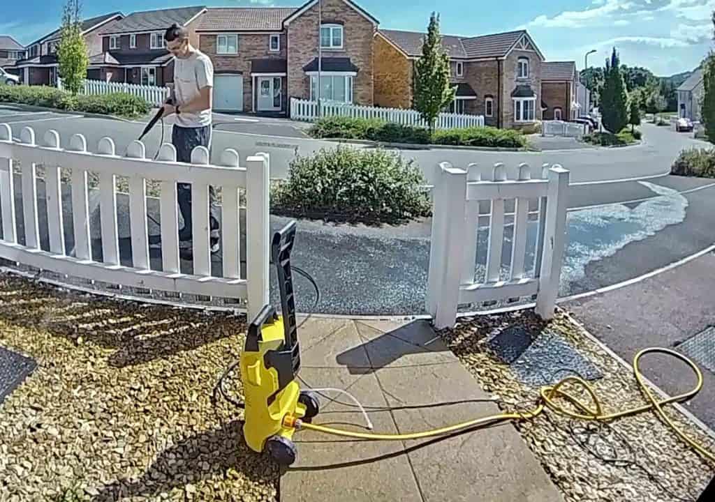 Me using a pressure washer to clean the floor outside my property